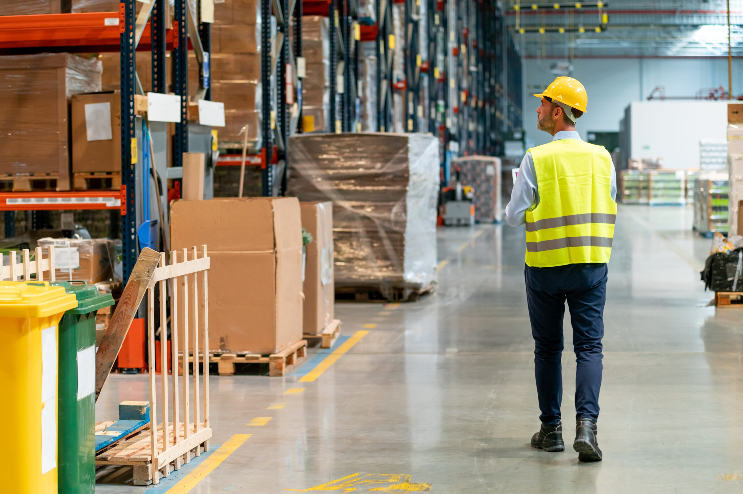 Warehouse worker using laptop and entering data to database